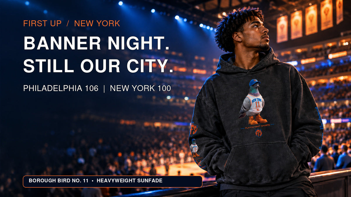 Banner Night. Still Our City. A fan wears the Borough Bird No. 11 Heavyweight Sunfade Hoodie beneath championship banners at Madison Square Garden.